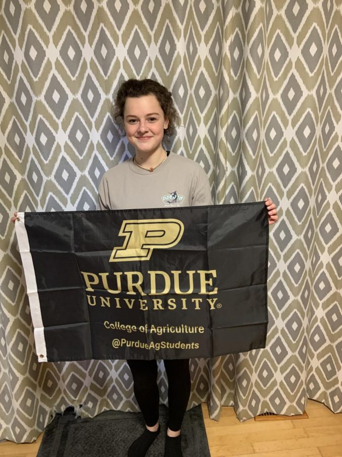 POSE: Larrison poses for the camera holding a Purdue University sign where she will be attending  in the fall. 
