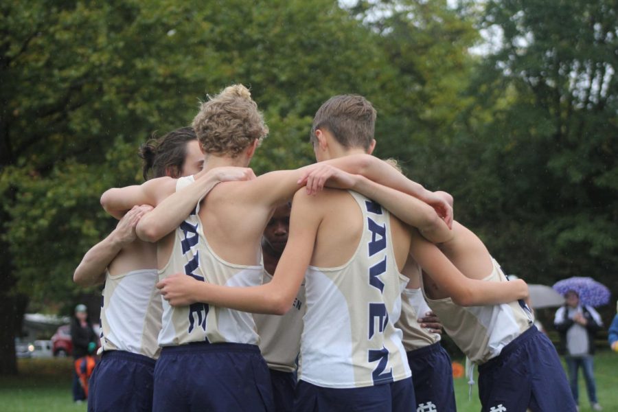 The+boys+cross+country+team+share+a+hug+before+running+in+the+O-K+Red+conference+meet+in+2021.+Norder+and+Clark+are+off+to+a+great+start+this+year%2C+both+running+personal+best+times+at+the+MSU+meet.+