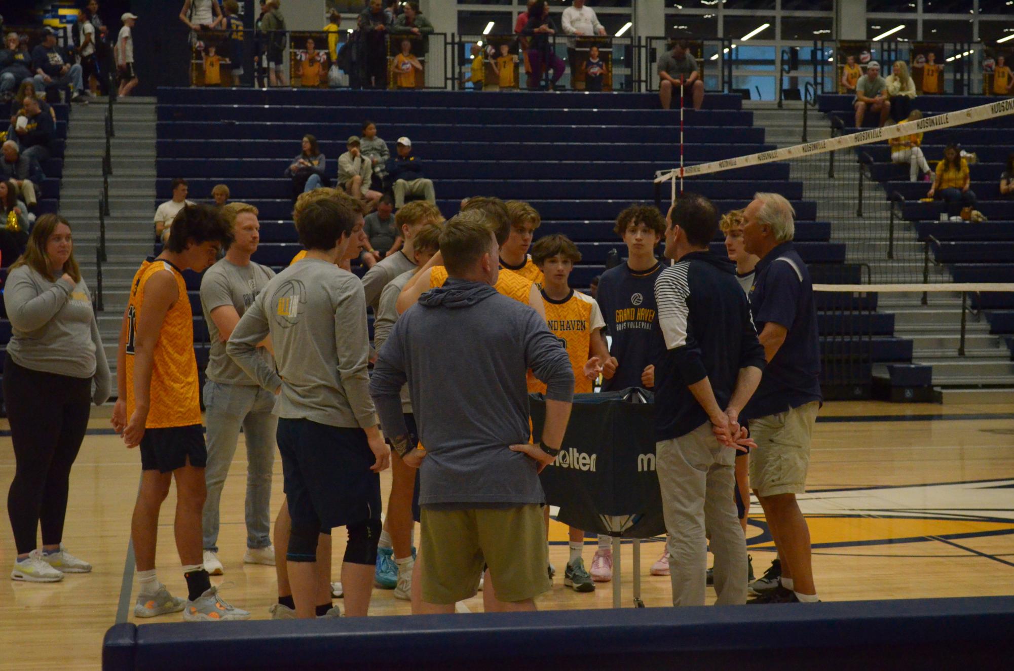 The boys volleyball coaches prepare the team for the state semifinal game where they won 3-0. The finals match will be held at Cornerstone University on Friday, May 31 at 7 p.m.