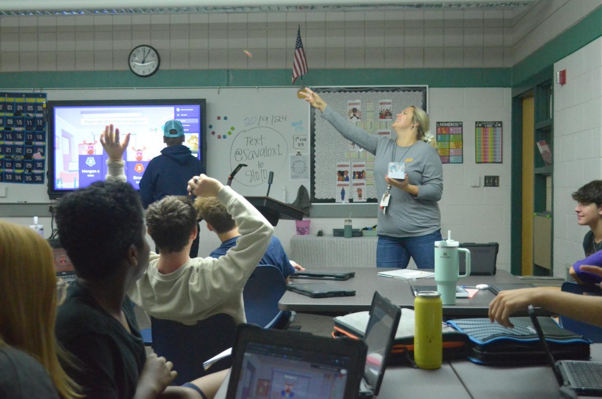 Emily Savalox throws candy to a student for winning a spanish Kahoot. Savalox is incredibly expressive and it shows in her teaching style. 