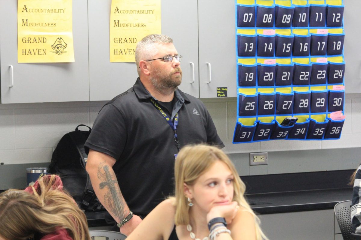 Teaching assistant Dustin Parlin attentively stands in the back of Mr. Russell’s biology class ready to help. Parlin’s presence helps both the students and teachers throughout the year. 