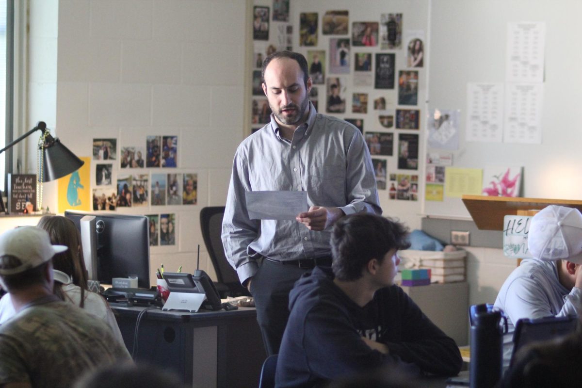 Premier substitute teacher Andrew Belsito explains the instructions Brooke Smeckert left for her public speaking class. "When I was in high school, I asked myself, what am I going to be doing with my life and teaching was the main thing I gravitated towards," said Belsito. 