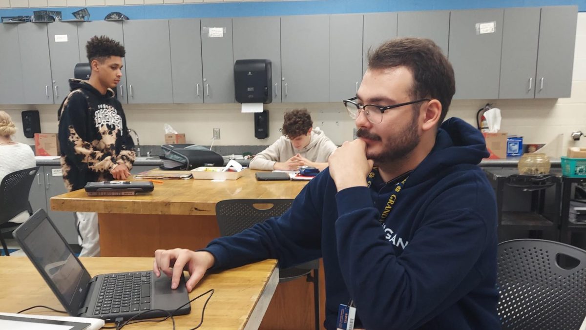 Mr. Golden reviews student work. He’s the newest art teacher at Grand Haven Highschool
