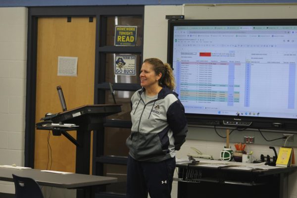 Coach Katie Kowalczyk-Fulmer standing in front of her academy class in room 0200. She works as a Physical Education Teacher and as the coach of the Girls' Basketball Team.