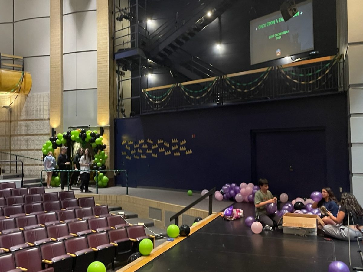 Orchestra students set up decorations in the Performing Arts Center. Work on the decorations started on Tuesday and were completed Wednesday. 