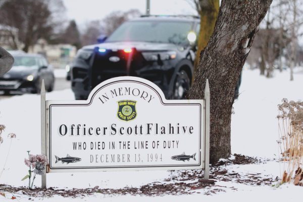 A police cruiser parked behind the Scott Flahive memorial in the median at the intersection at Taylor and US-31. Officer Flahive was shot and killed in the line of duty On Dec. 13, 1994. 